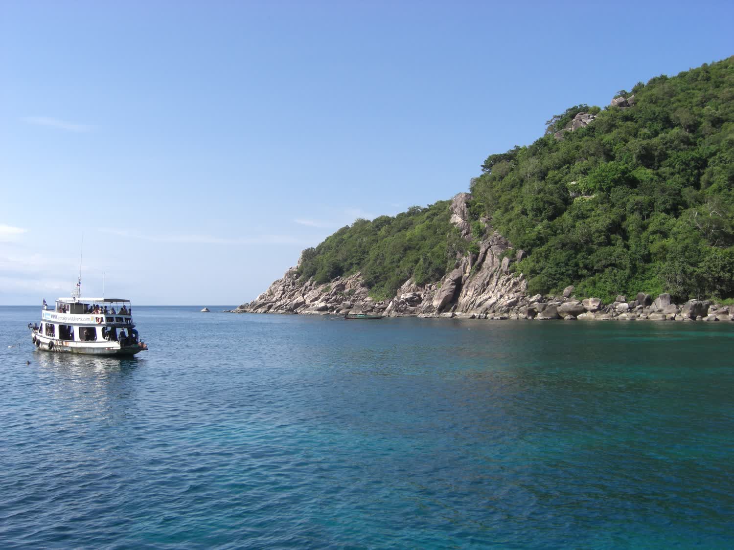Mango Bay on Koh Tao framed by headlands and moored longtail boats